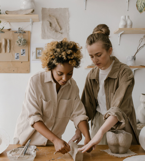 Women working together on pottery.